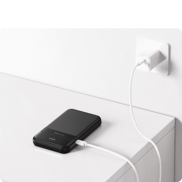 Power bank charging from wall socket, portable energy storage device for renewable energy, eco-friendly power solution, ecoflow.ie product for outdoor and emergency power needs.